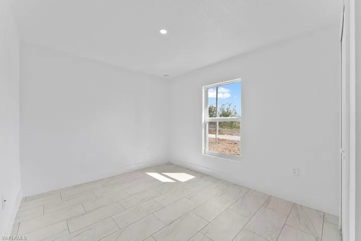 Unfurnished room with baseboards