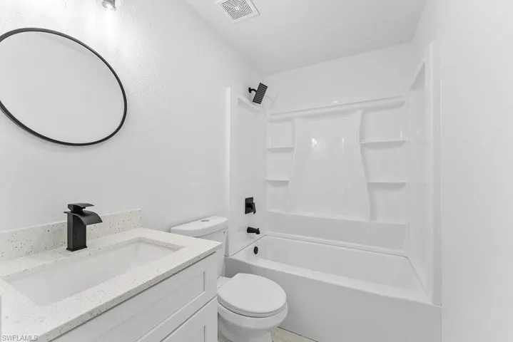Bathroom with vanity and shower / tub combination