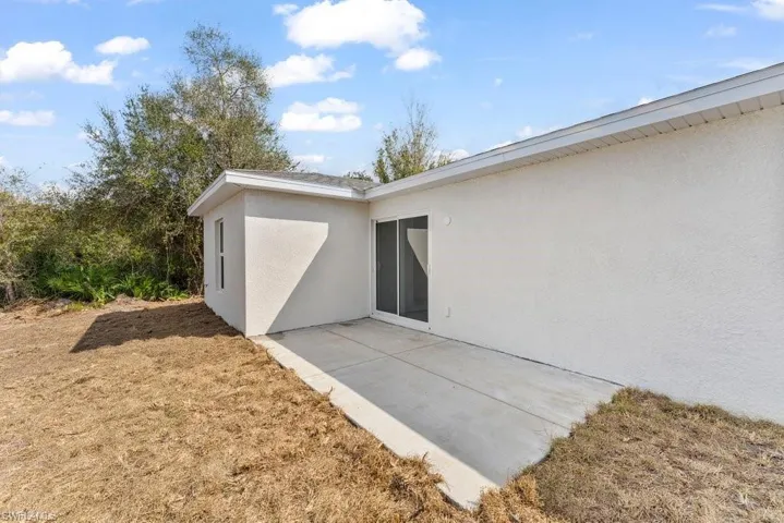 Property entrance featuring a patio and stucco siding