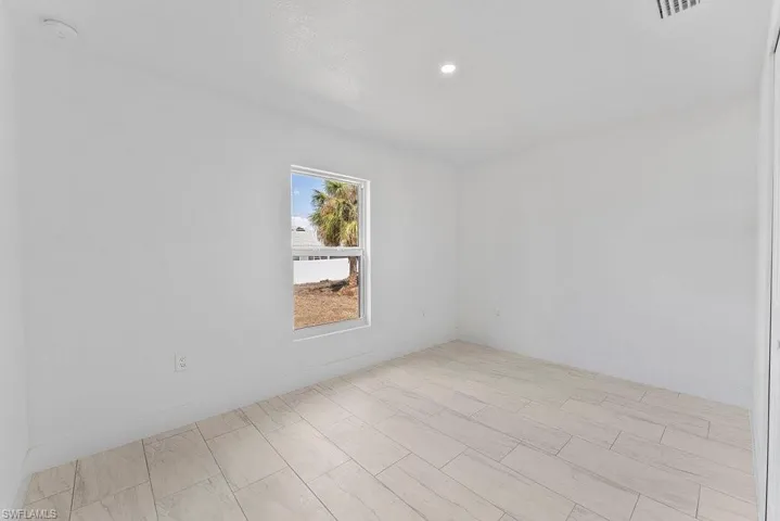 Spare room with baseboards and recessed lighting