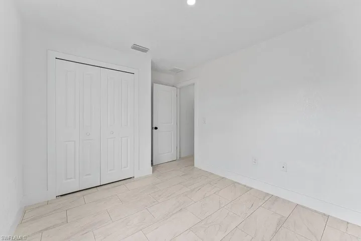 Unfurnished bedroom with a closet and baseboards