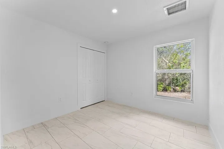 Unfurnished bedroom featuring a closet and recessed lighting
