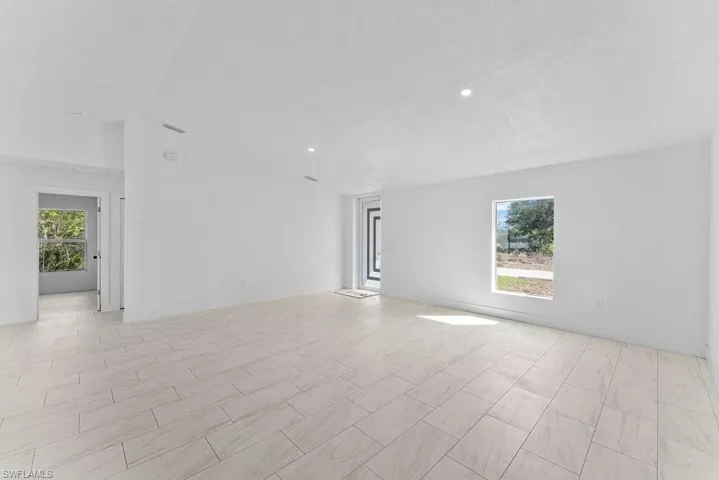 Empty room with plenty of natural light and recessed lighting