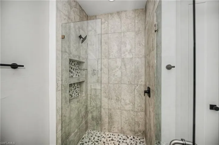 Full bathroom with a shower stall