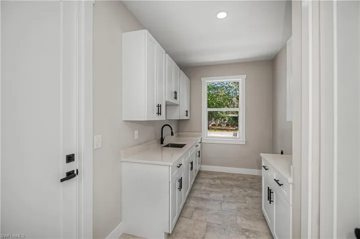 Laundry area featuring baseboards