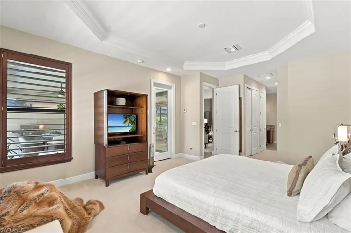 Primary bedroom offers lanai/pool access.