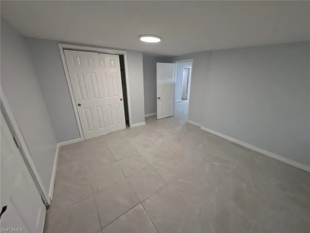 Unfurnished bedroom featuring light tile patterned floors
