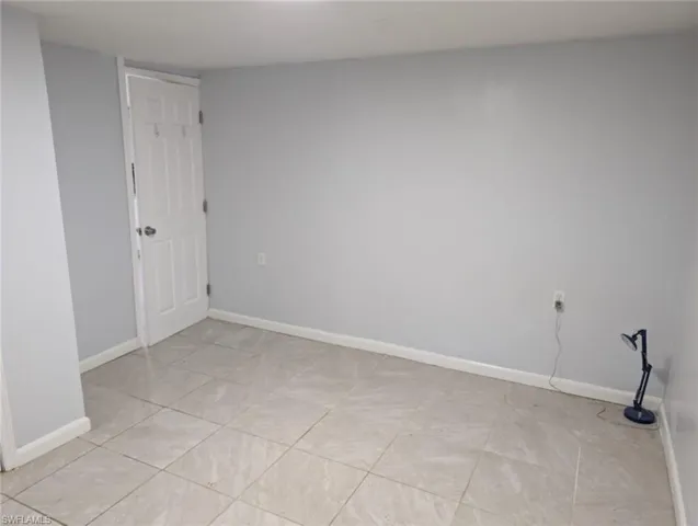 Empty room with light tile patterned floors