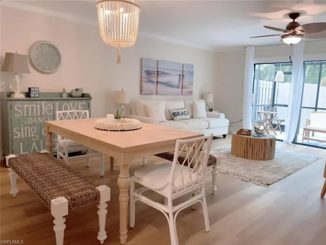 Dining space featuring wood finished floors, ceiling fan, and ornamental molding