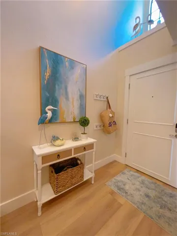 Entryway featuring baseboards and light wood finished floors