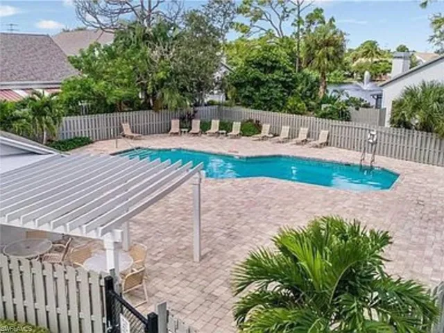 Community pool with a patio area and a pergola