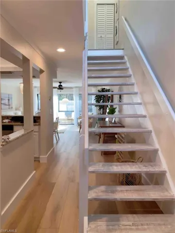 Stairway featuring wood finished floors, recessed lighting, and a ceiling fan