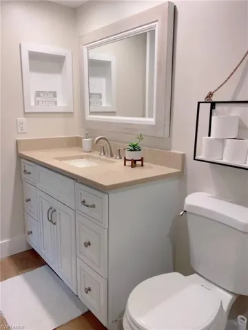 Half bath featuring vanity and toilet