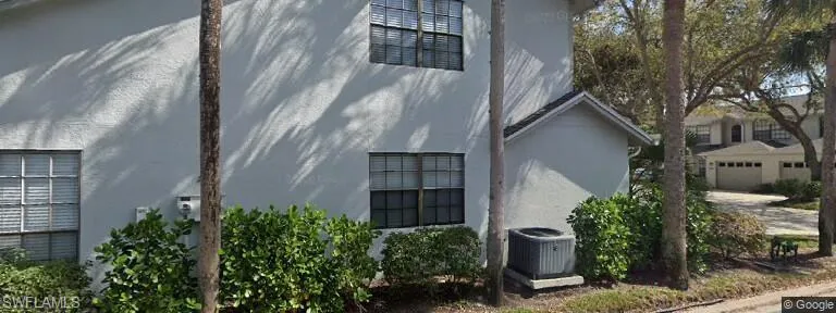 View of property exterior with stucco siding and a cooling unit