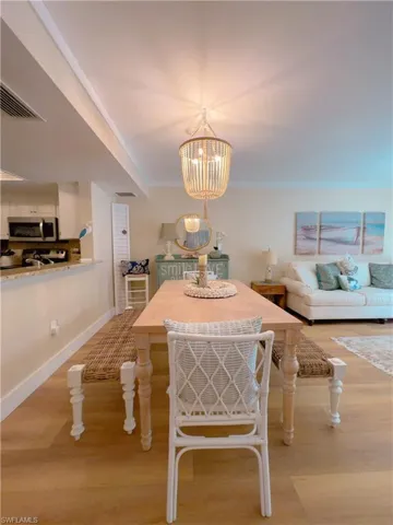 Dining area featuring light wood-style floors and a chandelier
