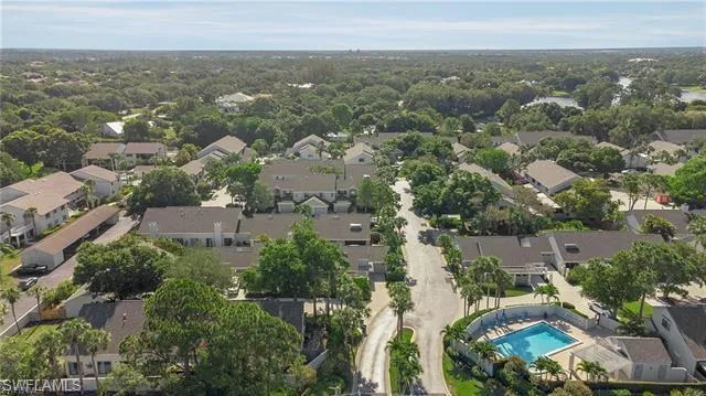Aerial view of property and surrounding area featuring nearby suburban area