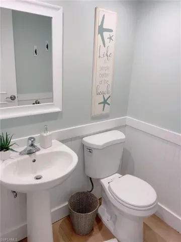 Bathroom with toilet and wainscoting