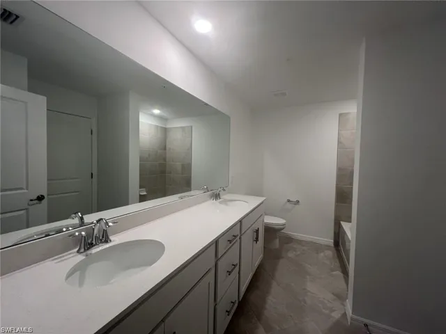 Full guest bath with double vanity, a bath, recessed lighting, and a shower