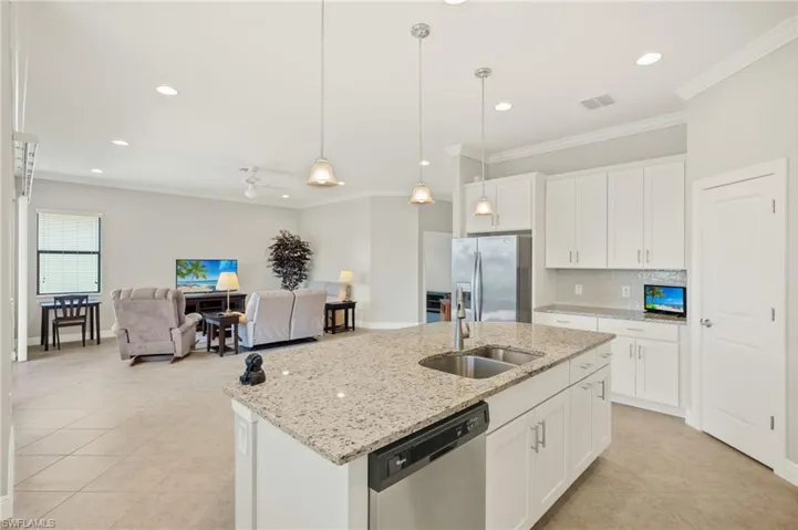 Kitchen with ornamental molding, visible vents, a sink, and appliances with stainless steel finishes