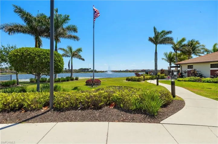 View of home's community with a lawn and a water view