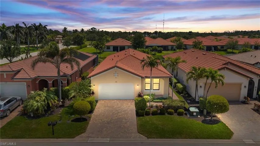 Mediterranean / spanish-style home with a garage, a tile roof, stucco siding, and decorative driveway