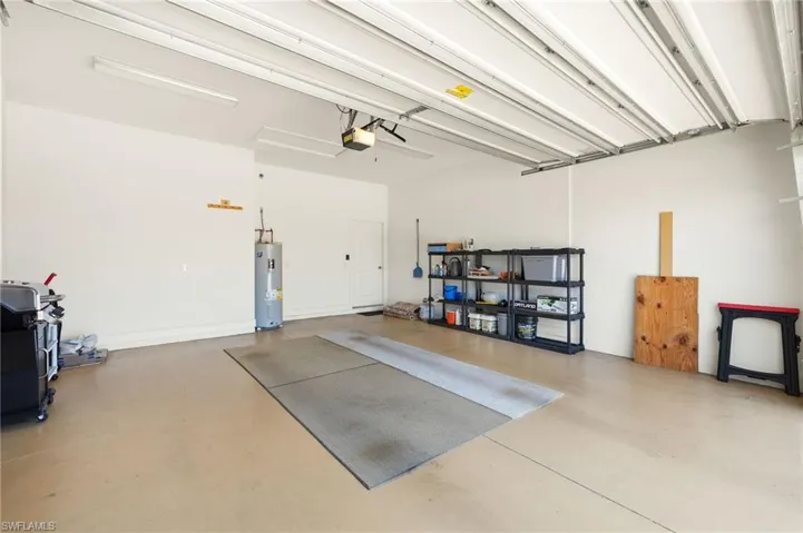 Garage with a garage door opener and electric water heater