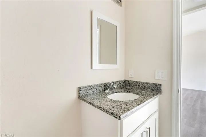 Bathroom with vanity and wood finished floors