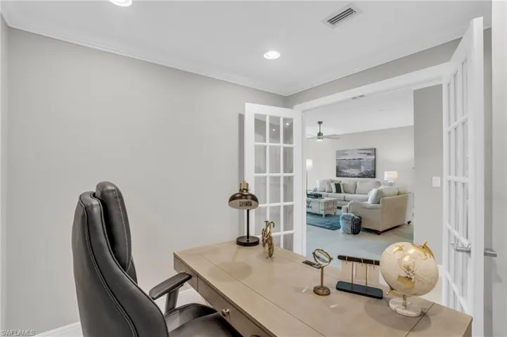 Home office featuring ceiling fan, french doors, and crown molding