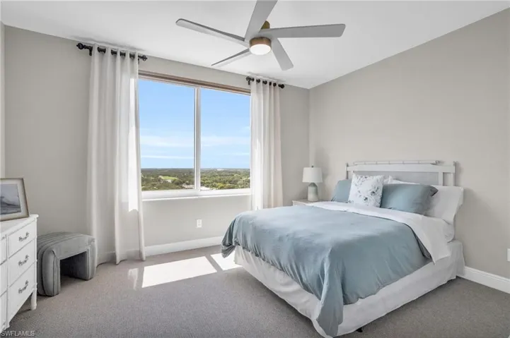 Bedroom featuring ceiling fan and carpet floors
