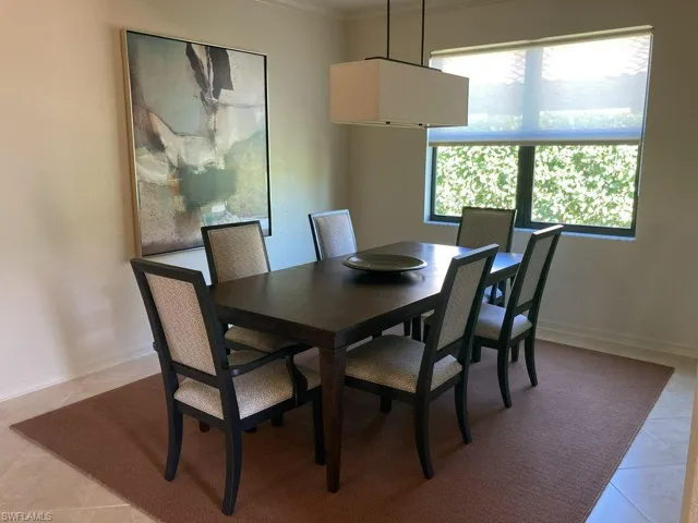 Dining space featuring tile flooring and ornamental molding