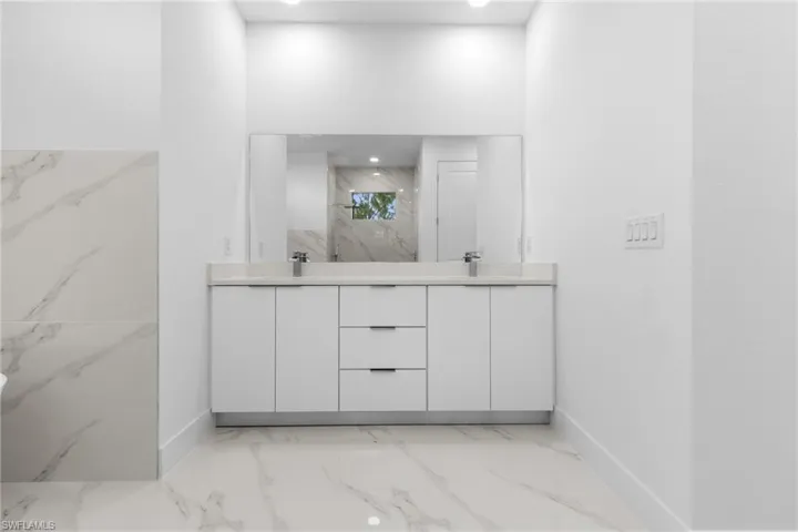 Bathroom with tile flooring and double sink vanity