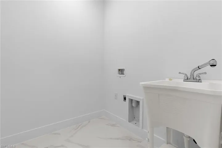Clothes washing area with laundry tub, washer hookup, and hookup for an electric dryer