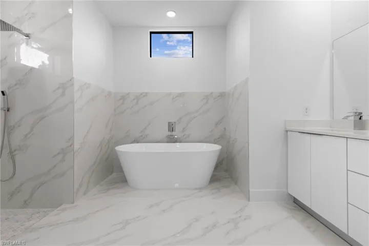 Bathroom featuring vanity, tile walls, and tile floors