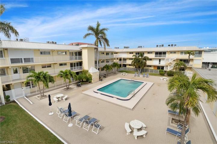 Community Poolwith individual covered and secure storage for every unit- perfect for beach supplies or bikes.