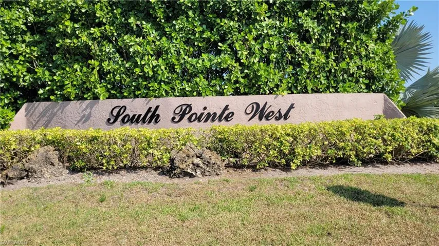 Community sign featuring a lawn