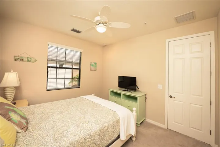 Bedroom featuring light carpet and ceiling fan