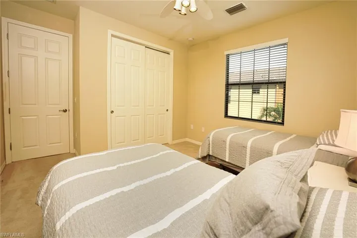 Bedroom with carpet flooring, a closet, and a ceiling fan