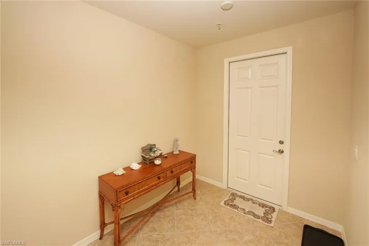 Tiled foyer entrance featuring baseboards