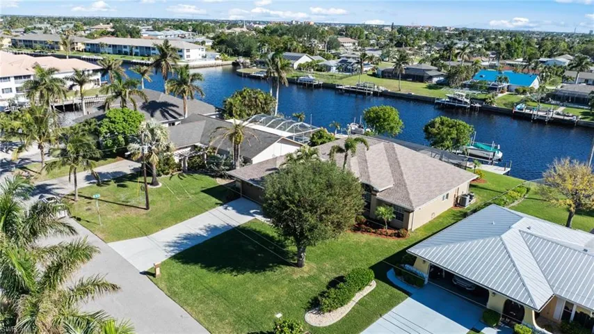Birds eye view of property with a water view