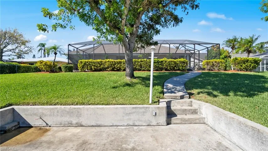View of yard featuring glass enclosure
