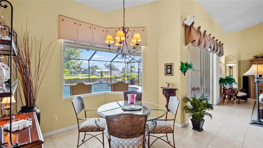 Tiled dining room featuring a chandelier