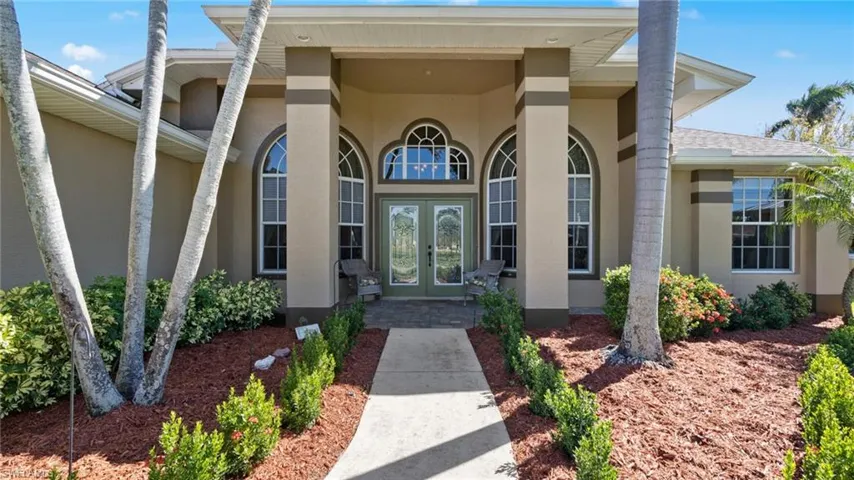 Property entrance featuring french doors