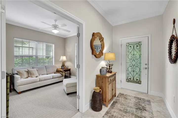 Entryway featuring crown molding and ceiling fan