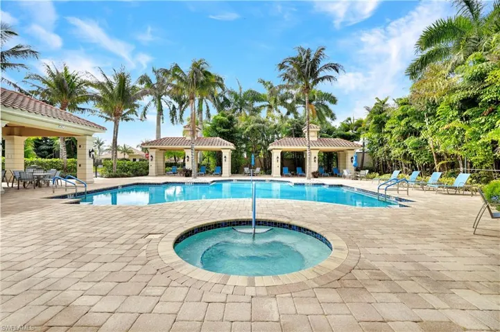 Community pool featuring a hot tub, a patio, and a gazebo