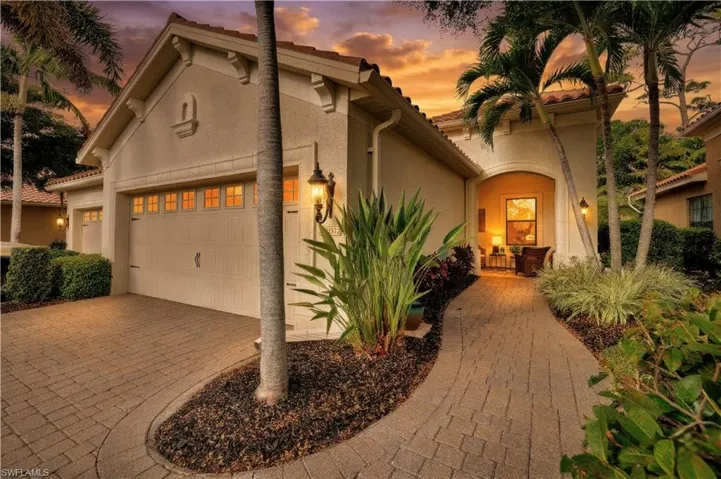 Mediterranean / spanish home with stucco siding, a garage, driveway, and a tile roof