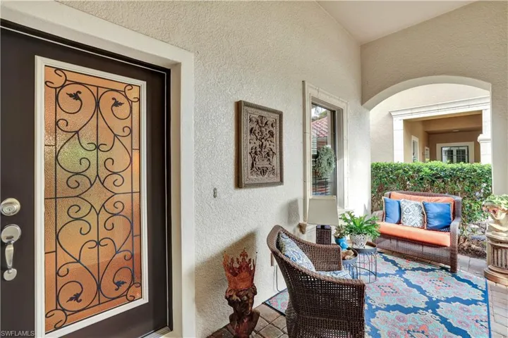 Doorway to property featuring stucco siding