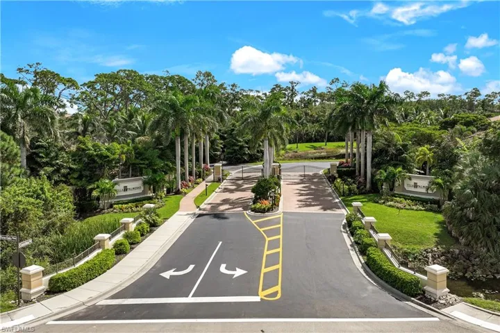 View of asphalt street featuring view of scattered trees and sidewalks