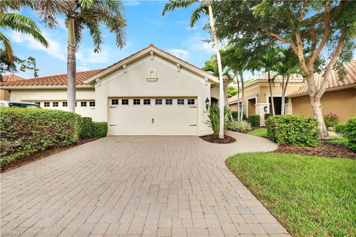 Mediterranean / spanish house featuring decorative driveway, stucco siding, an attached garage, and a tiled roof