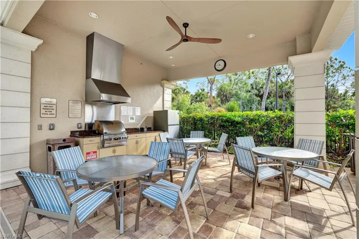 View of patio with a ceiling fan and an outdoor kitchen / dining area