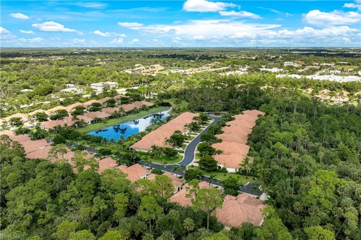 Aerial view of residential area featuring a nearby body of water